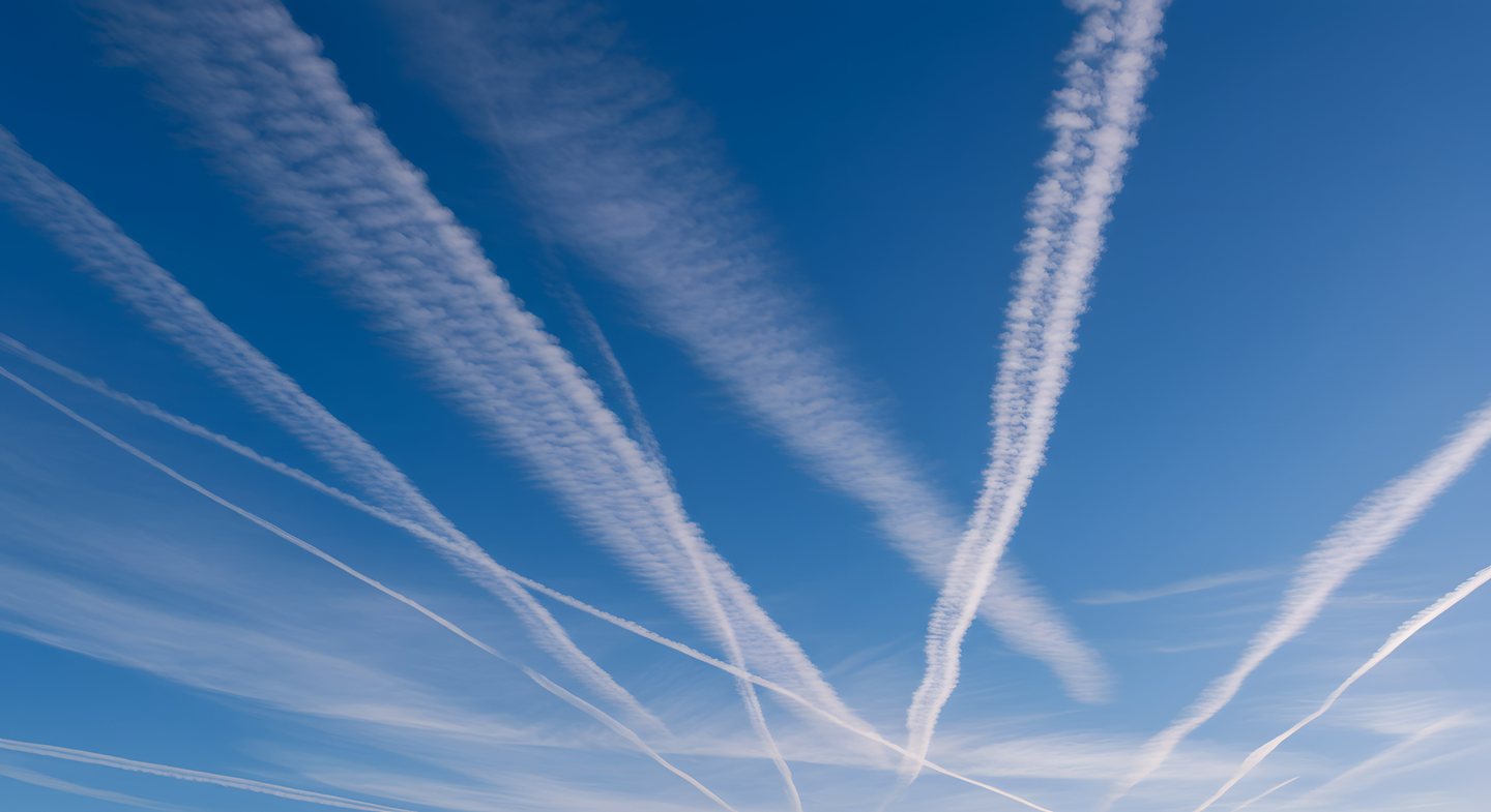 Aircraft contrails crossing a clear blue sky
